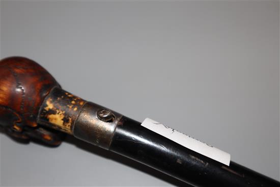 An ivory metamorphic skull cane handle, length 23.5cm